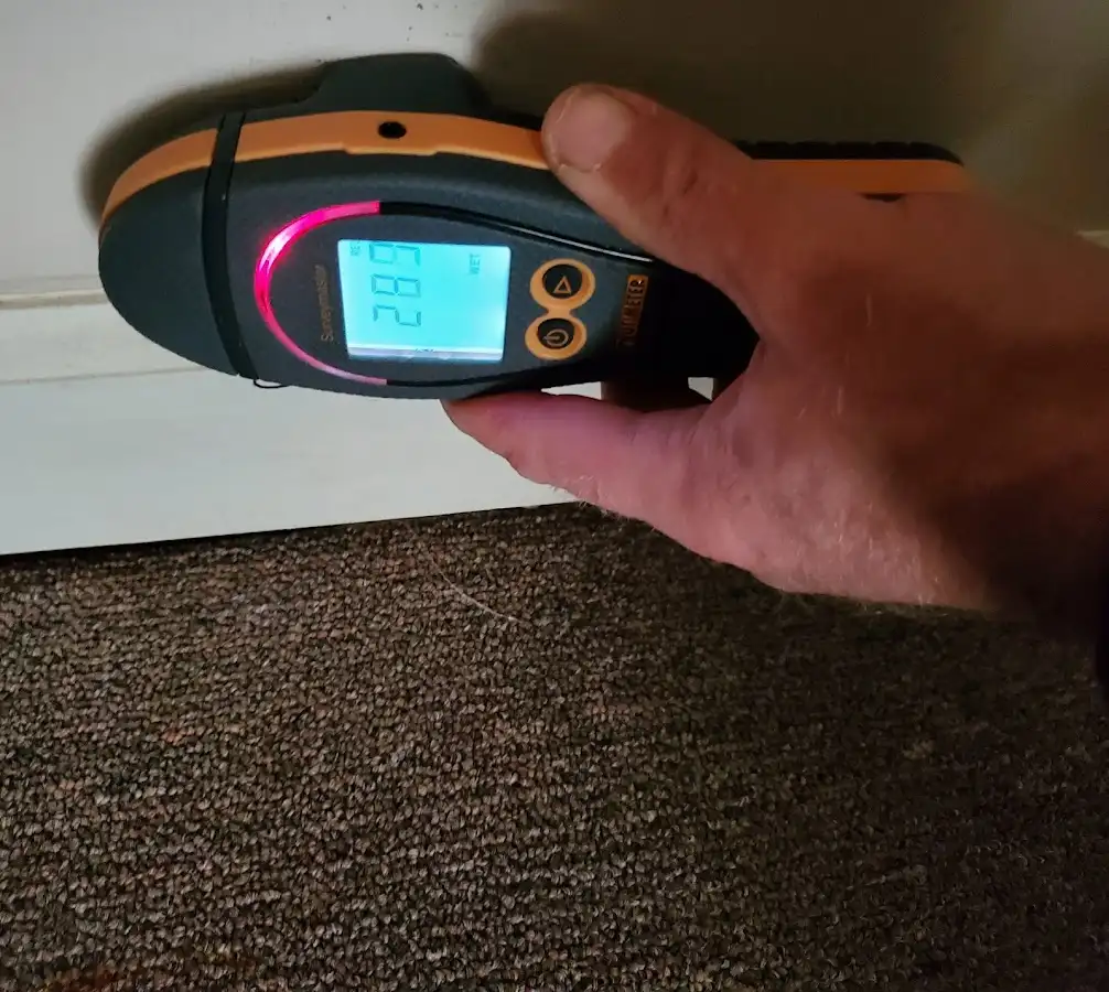 Moisture detection at baseboard during Storm Damage Restoration in Smithfield